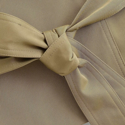 Close-up of the tie belt knot on the khaki trench waistcoat