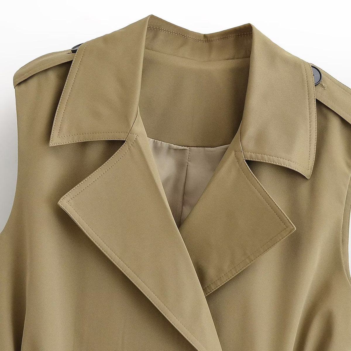 Close-up of the notch lapel collar and shoulder tabs on the khaki trench waistcoat