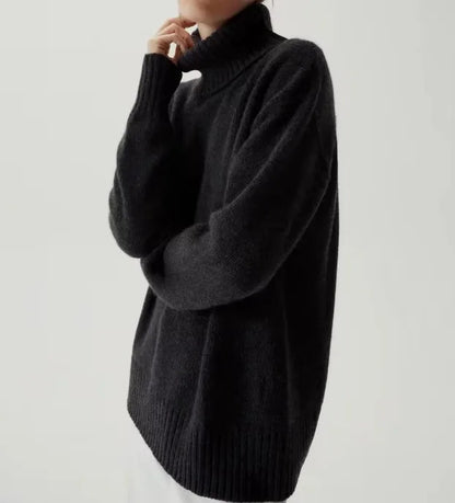 Woman wearing the Mabel Oversized Turtleneck Jumper in charcoal, front view